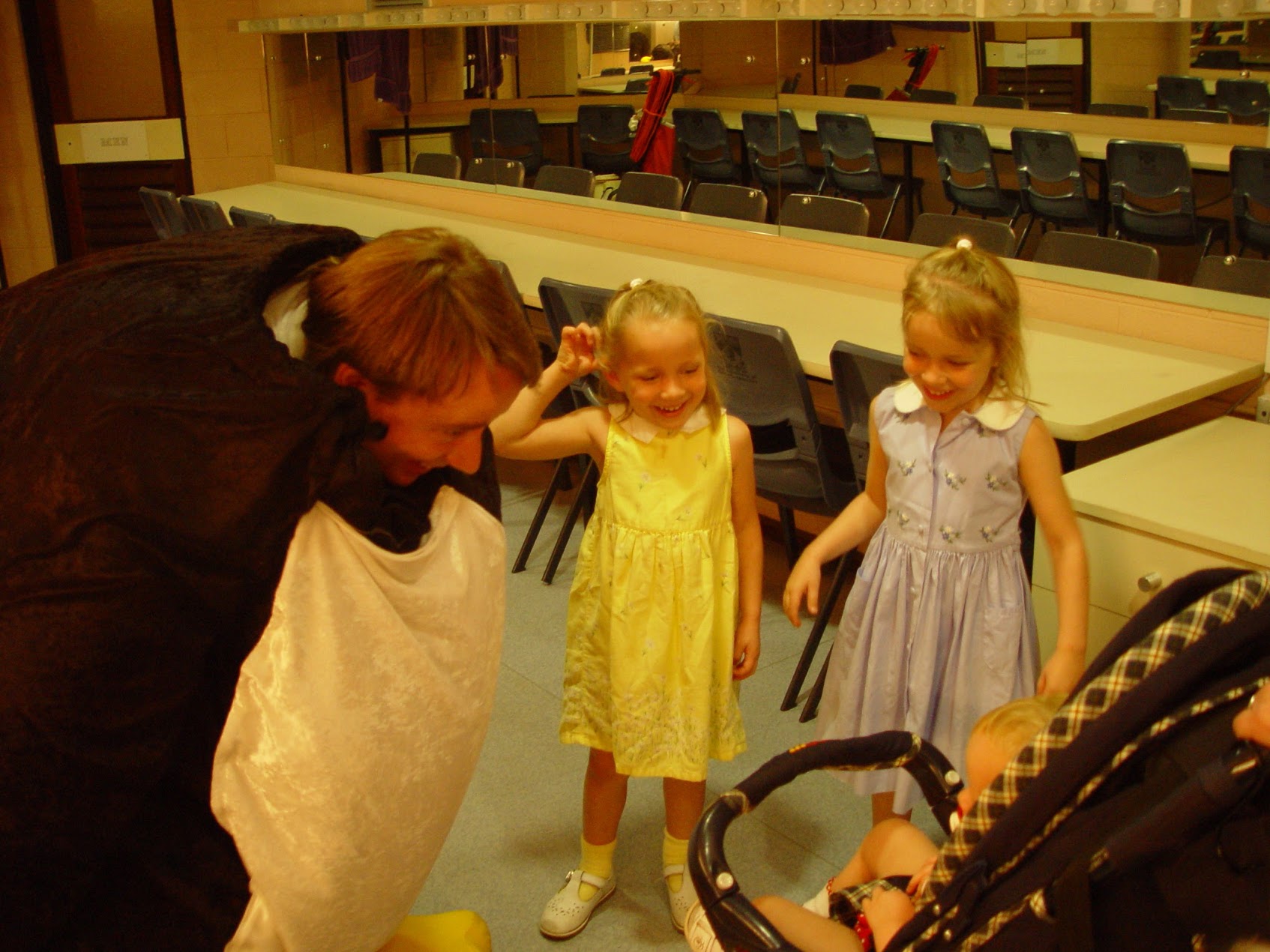 Linus in Penguin costume talking to his daughters